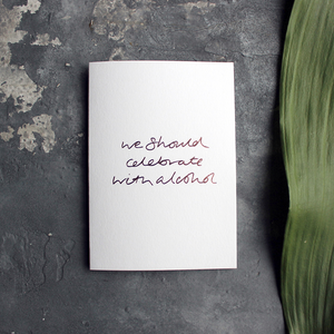 this rose gold hand foiled luxury card is printed with 'We Should Celebrate With Alcohol' on the front