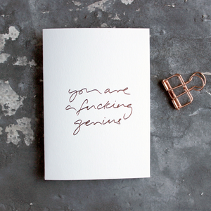 You Are A Fucking Genius is a luxury white card hand foiled in rose gold on the front