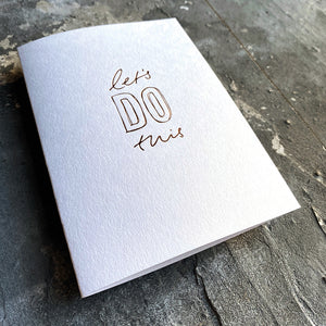 xThis luxThis luxury card has a hand written rose gold foil block message saying Let's Do This on the front